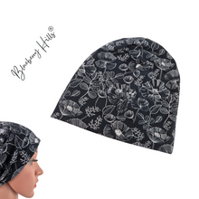 Lade das Bild in den Galerie-Viewer, Beanie "Svartlin" Damen schwarz weiß Jersey Blumen